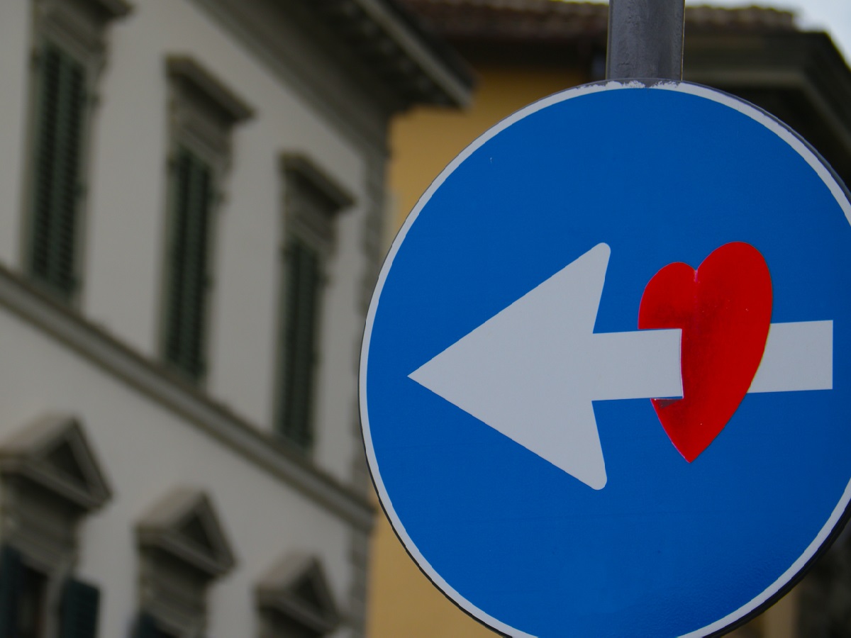 Street sign with arrow through a heart