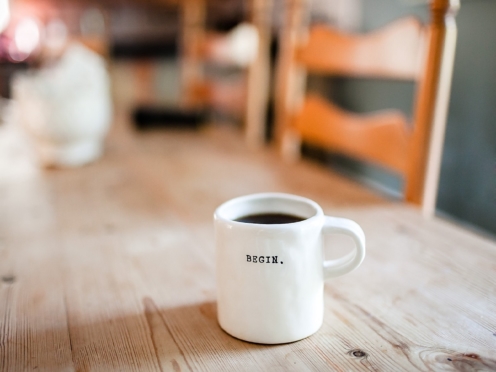 Coffee mug with 'begin' on it