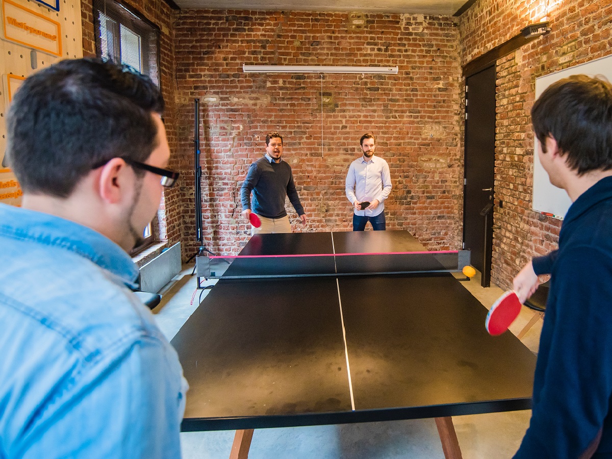 Engaged employees playing table tennis a way to prevent employee turnover