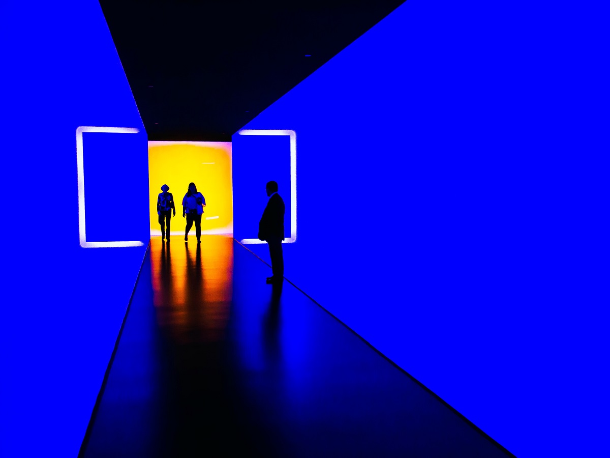 Long futuristic tunnel of light with people entering