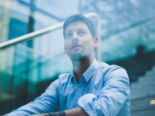 Man with high potential stares out of a window