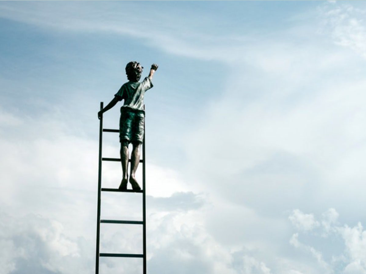 Person on ladder reaching for the sky