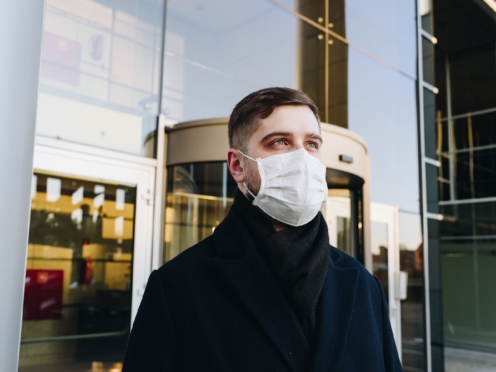 Man outside office wearing a mask